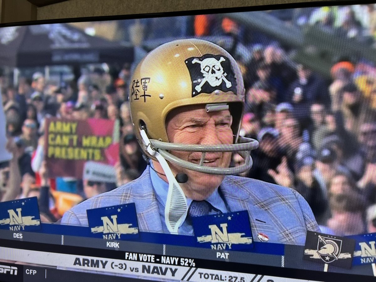 Bill Belichick wears a 1962 Navy helmet, complete with its own version of the ‘Jolly Roger,’ to make his guest pick for the Army-Navy game at Gillette Stadium.